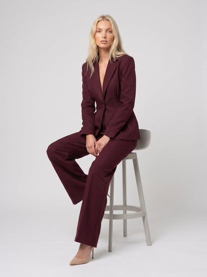 Compleu elegant vișiniu pentru damă format din sacou cambrat și pantaloni lungi cu croială largă, ideal pentru ținute office, business, elegante și evenimente speciale. Costum damă modern, confortabil și feminin, perfect pentru birou, petreceri, întâlniri și ocazii importante.