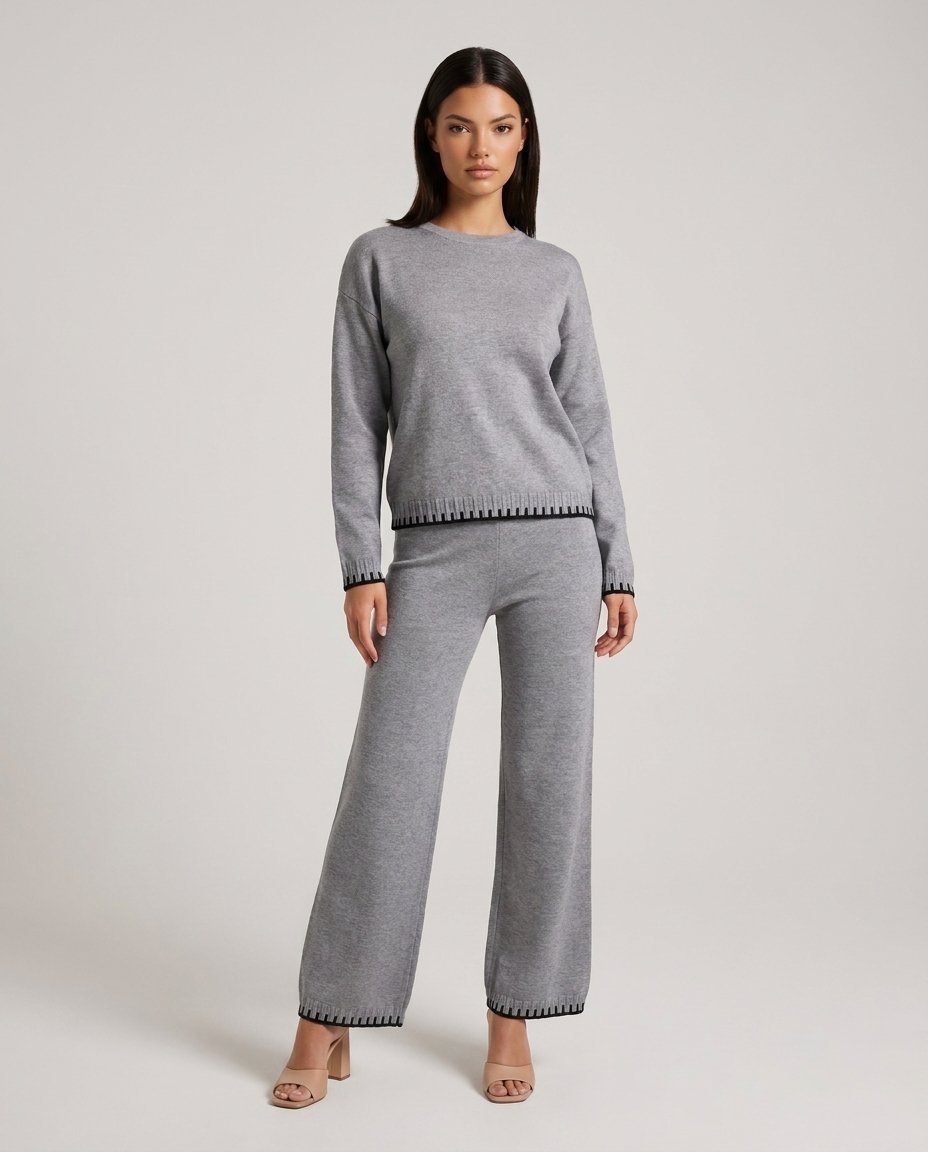 Set lounge tricot gri pentru damă, format din bluză lejeră și pantaloni lungi cu talie elastică și șnur reglabil, completat de detalii contrastante moderne. Compleu casual pentru femei, ideal pentru ținute de zi, călătorii, plimbări și confort zilnic.