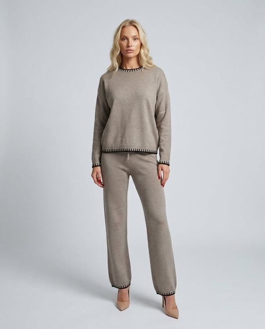 Set lounge tricot taupe pentru damă, format din bluză lejeră și pantaloni lungi cu talie elastică și șnur reglabil, completat de detalii contrastante moderne. Compleu casual pentru femei, ideal pentru ținute de zi, călătorii, plimbări și confort zilnic.
