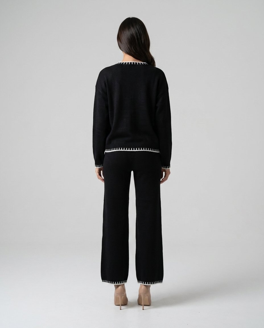 Compleu tricot negru pentru femei, cu bluză confortabilă și pantaloni lungi cu croială lejeră, realizat din material moale și plăcut la purtare. Set lounge pentru damă, perfect pentru outfituri casual chic, vacanțe, ieșiri în oraș și timpul liber.